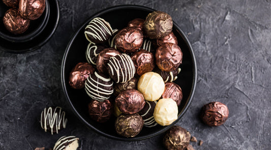 Apologies for theBonbon vs truffle: A close-up comparison of chocolate bonbons and truffles, highlighting their smooth fillings and decorative coatings.