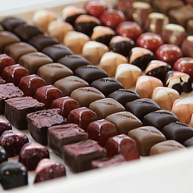 Chocolate products beautifully arranged in box.