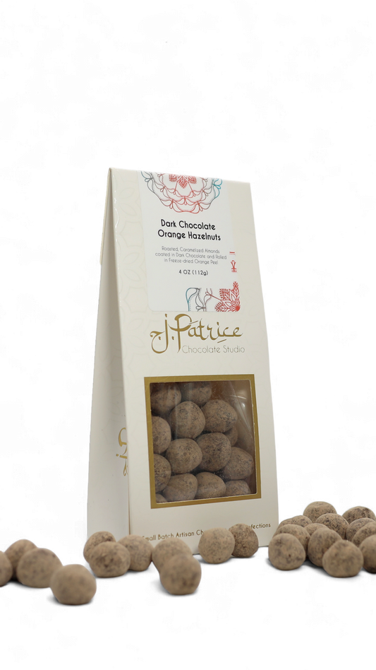 Pack of Dark Chocolate Orange Hazelnuts featuring crunchy hazelnuts coated in rich dark chocolate with a zesty orange flavor.